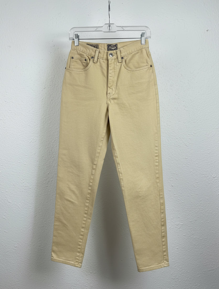 yellow pants on a hanger in a store setting 