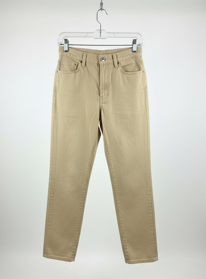 yellow pants hanging on a rack in a store setting